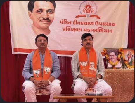 Hardikbhai Tamaliya seated at stage program
